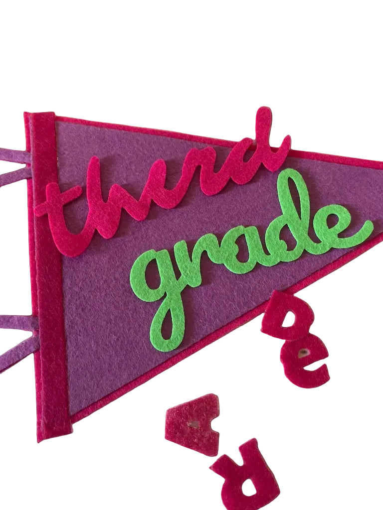 Felt banner with 'third grade' text 