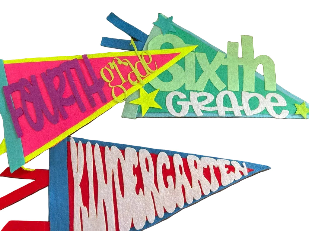 Colorful pennant flags indicating 'Fourth Grade', 'Sixth Grade', and 'Kindergarten' on a wooden surface.